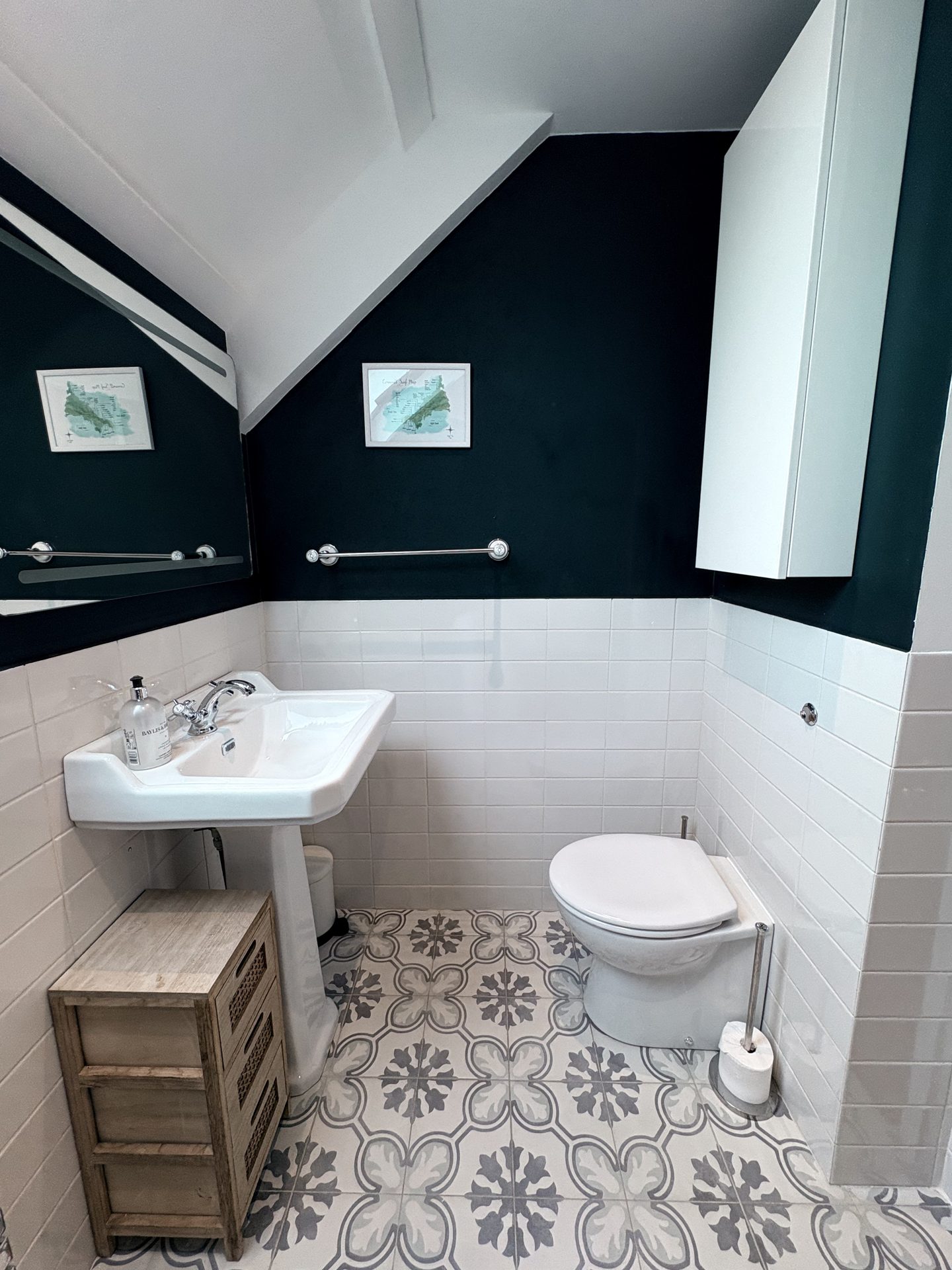 Bathroom with dark green tiles and patterned floor