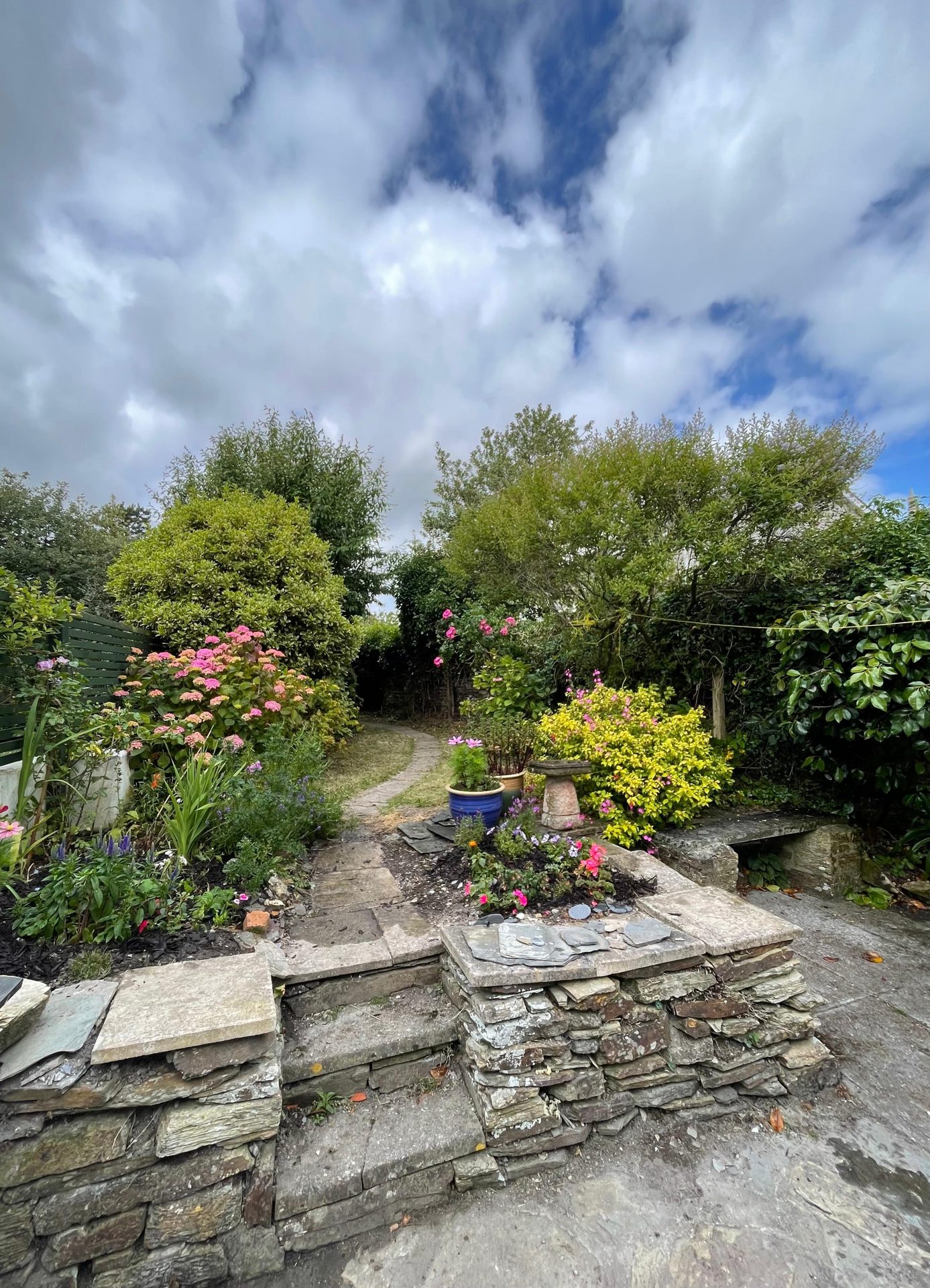 Stone garden path lined with flowers