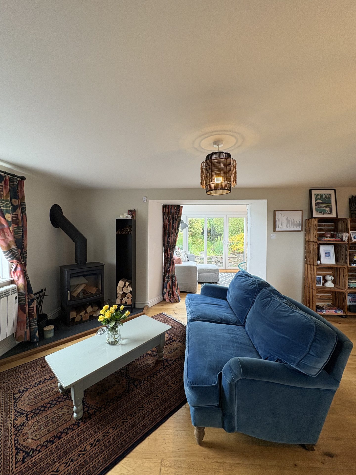 Sitting room with wood-burning stove and blue sofa